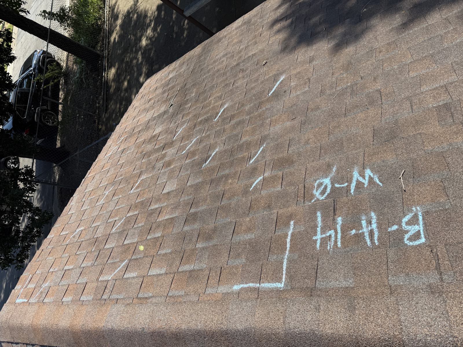 Adjuster test square and date chalked onto the slope