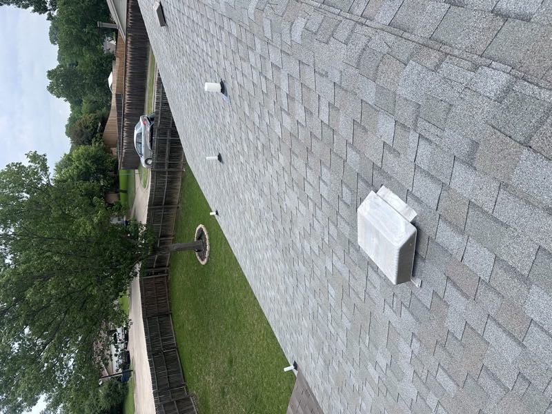 Roof vents across a shingle field from above