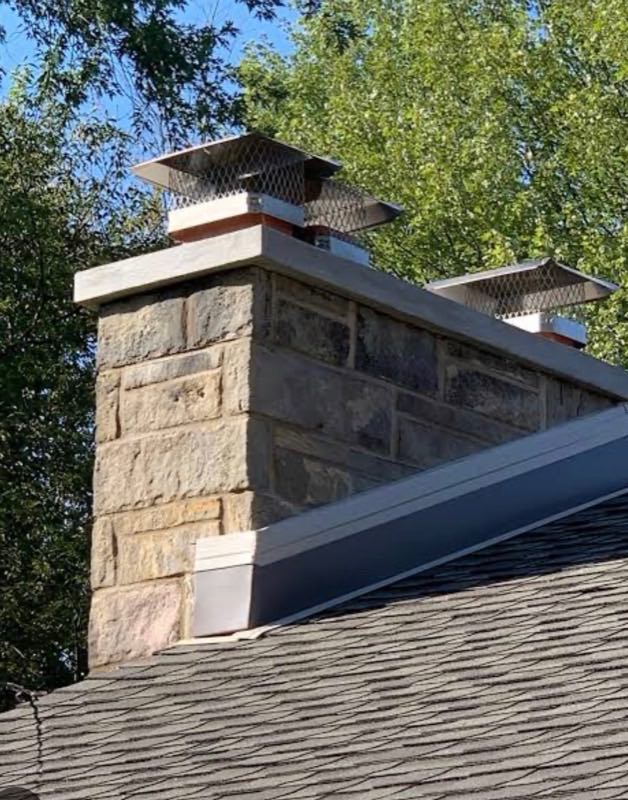 Stone chimney with new metal caps