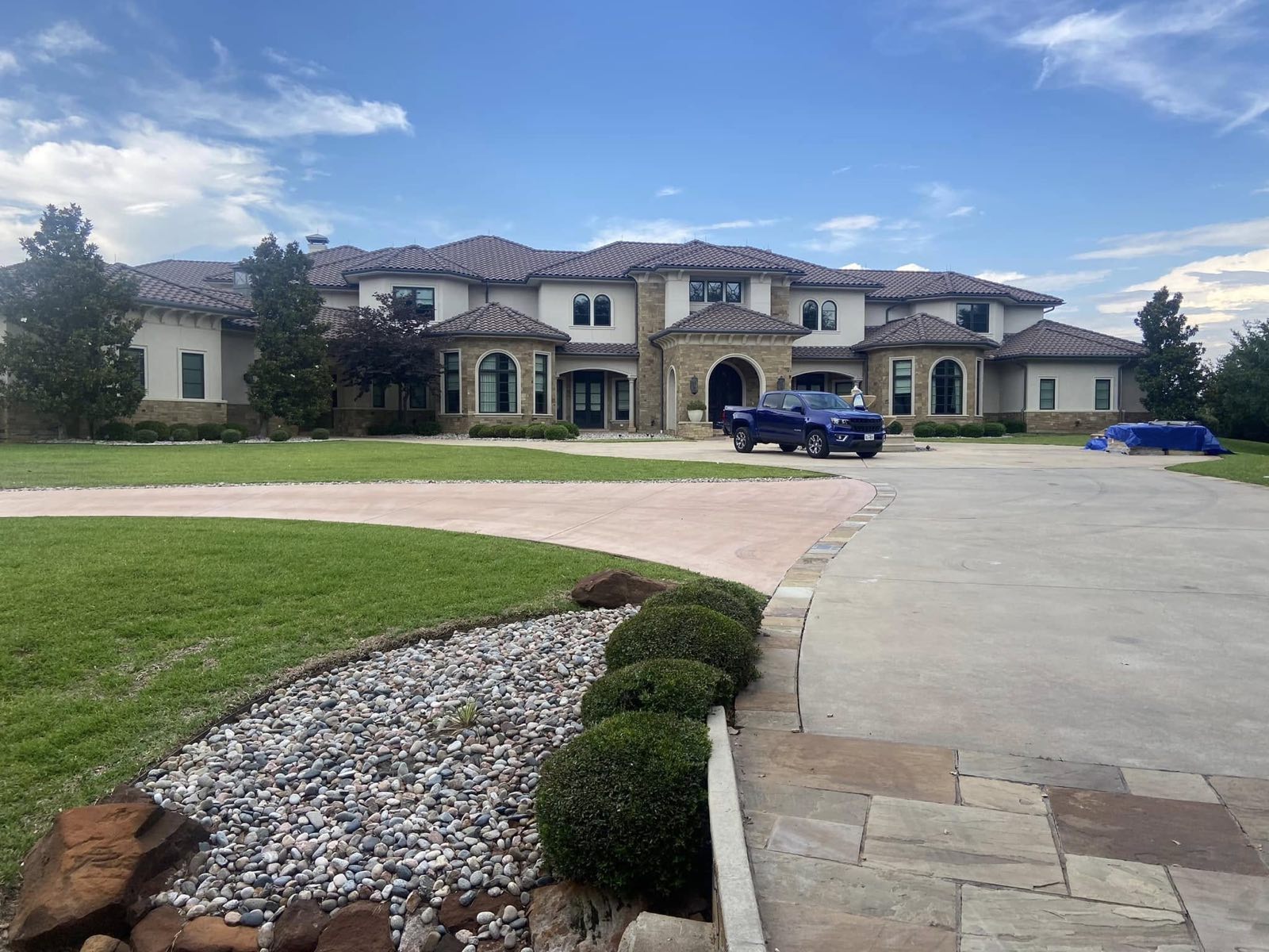 Two story home with stone drive and finished landscaping