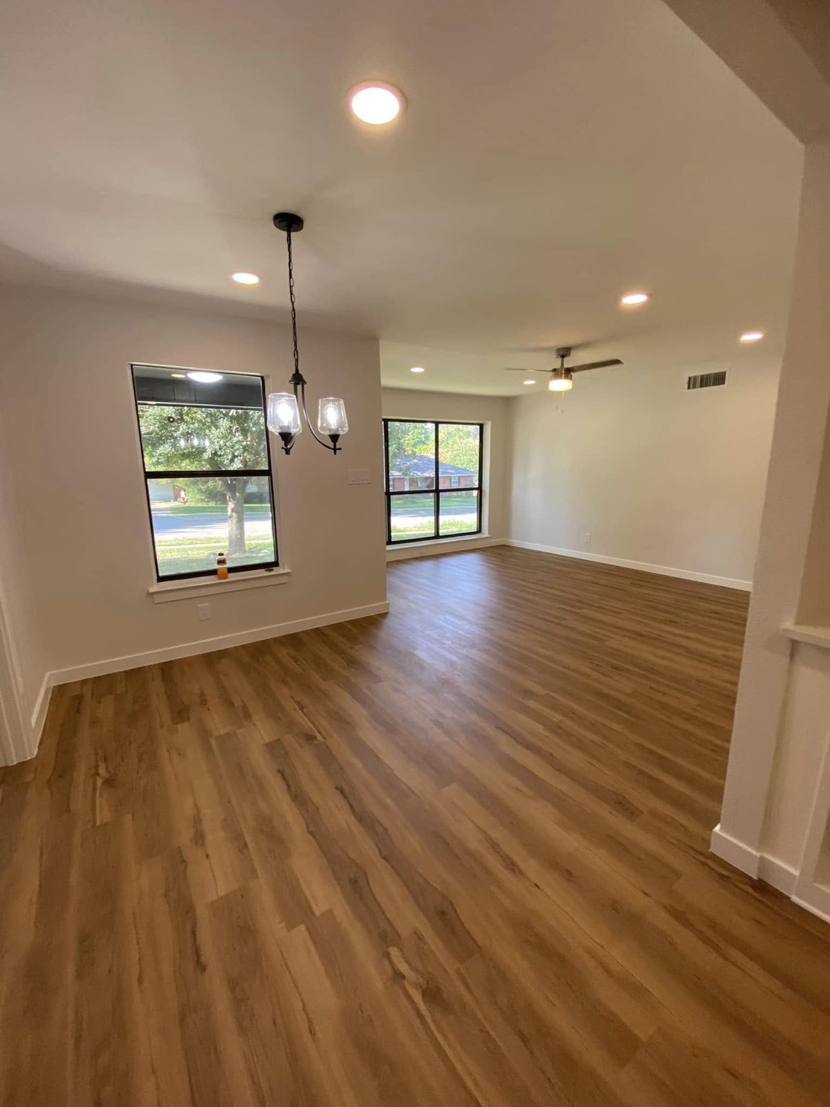 Open living and dining space with pendant lights