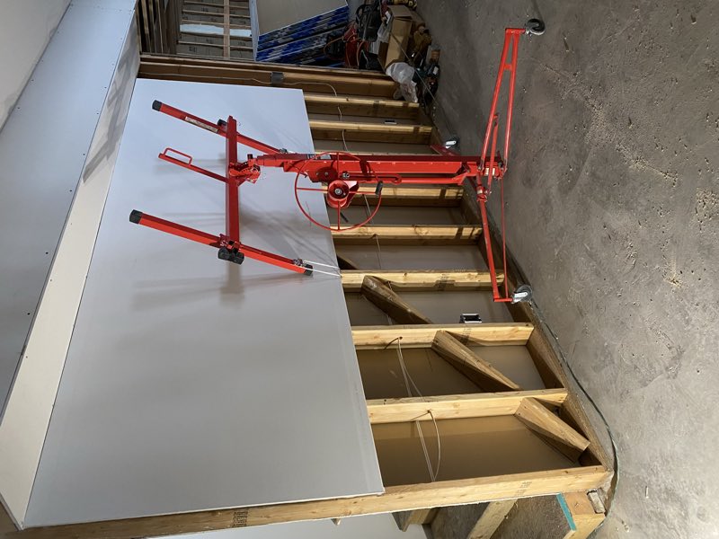 Setting a drywall panel with a lift