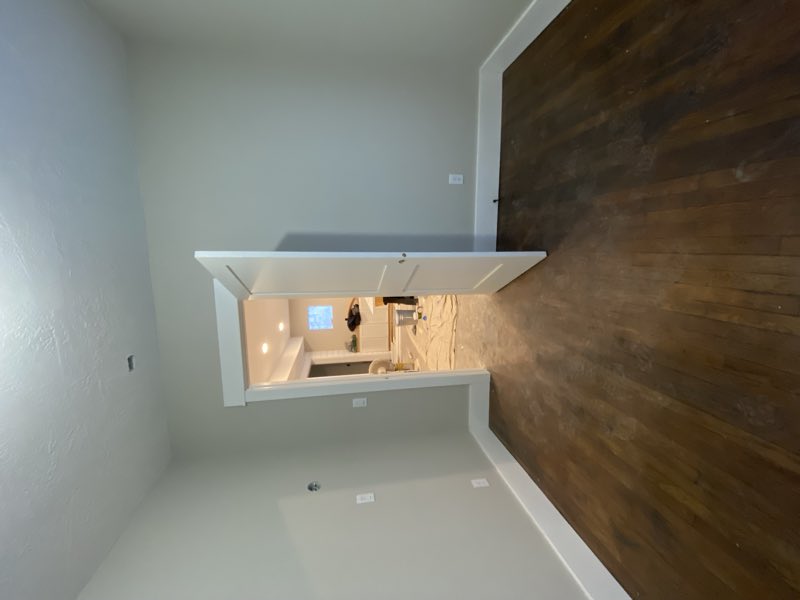 Bedroom with dark hardwood floor and new baseboards